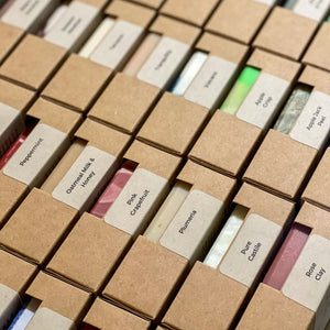 Artisan Handmade soaps placed in rows, labeled and packaged in kraft boxes