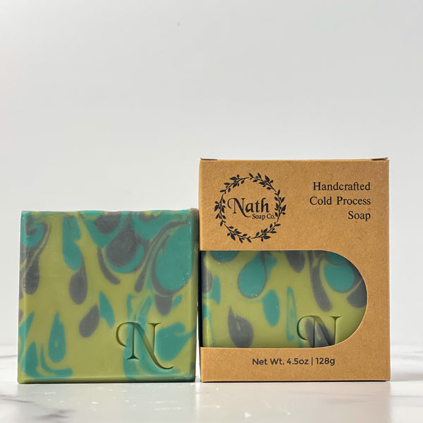 2 green and black and soaps, one packaged in a kraft colored box, one without box